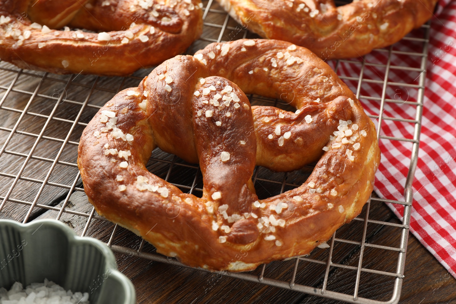 Tasty pretzels with salt on wooden table, closeup Photo of Tasty pretzels with salt on wooden table, closeup