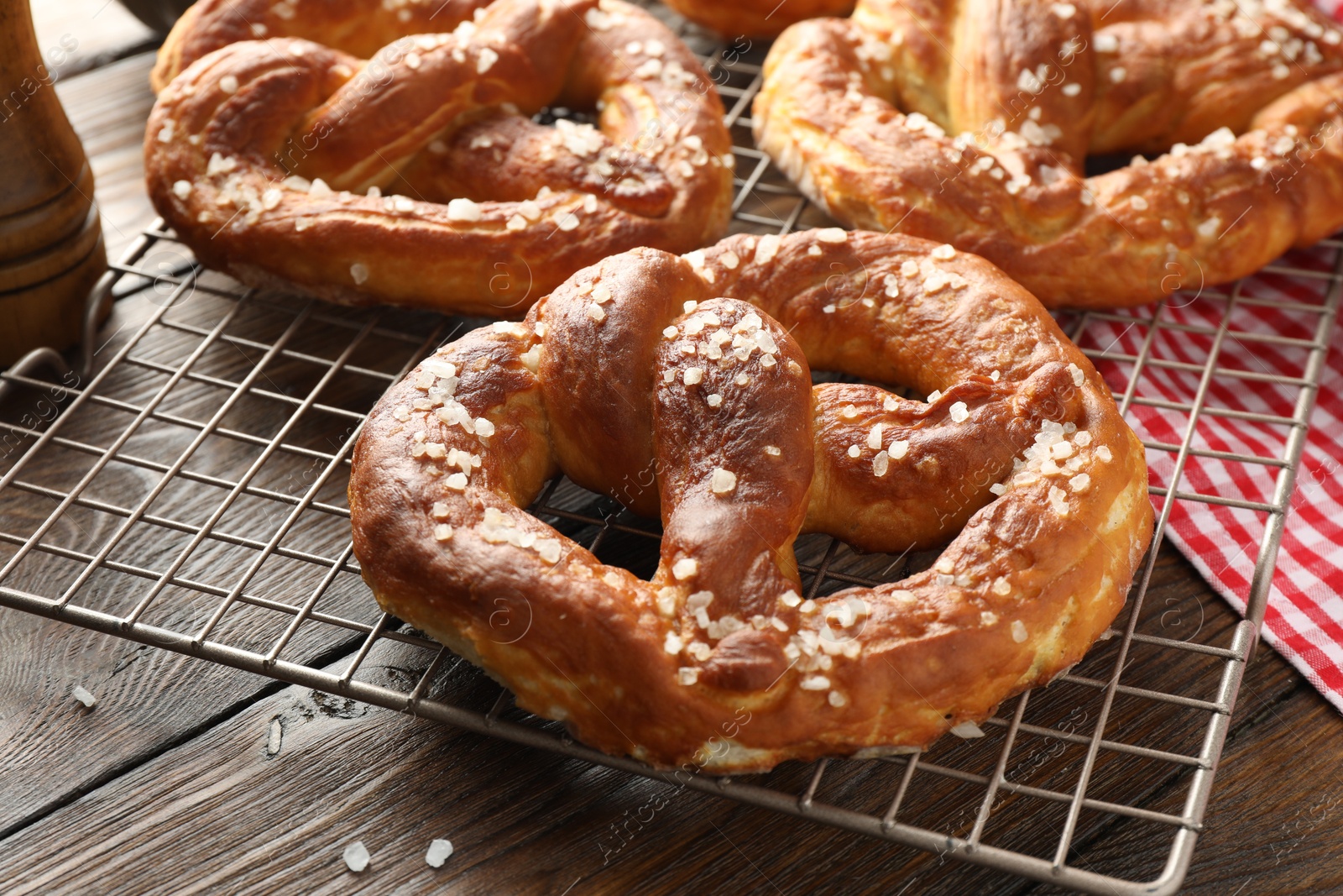 Tasty pretzels with salt on wooden table, closeup Photo of Tasty pretzels with salt on wooden table, closeup