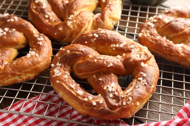 Photo of Tasty pretzels with salt on table, closeup