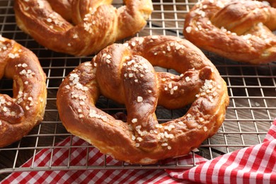 Photo of Tasty pretzels with salt on table, closeup