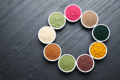 Photo of Different superfood powders on black table, flat lay. Space for text