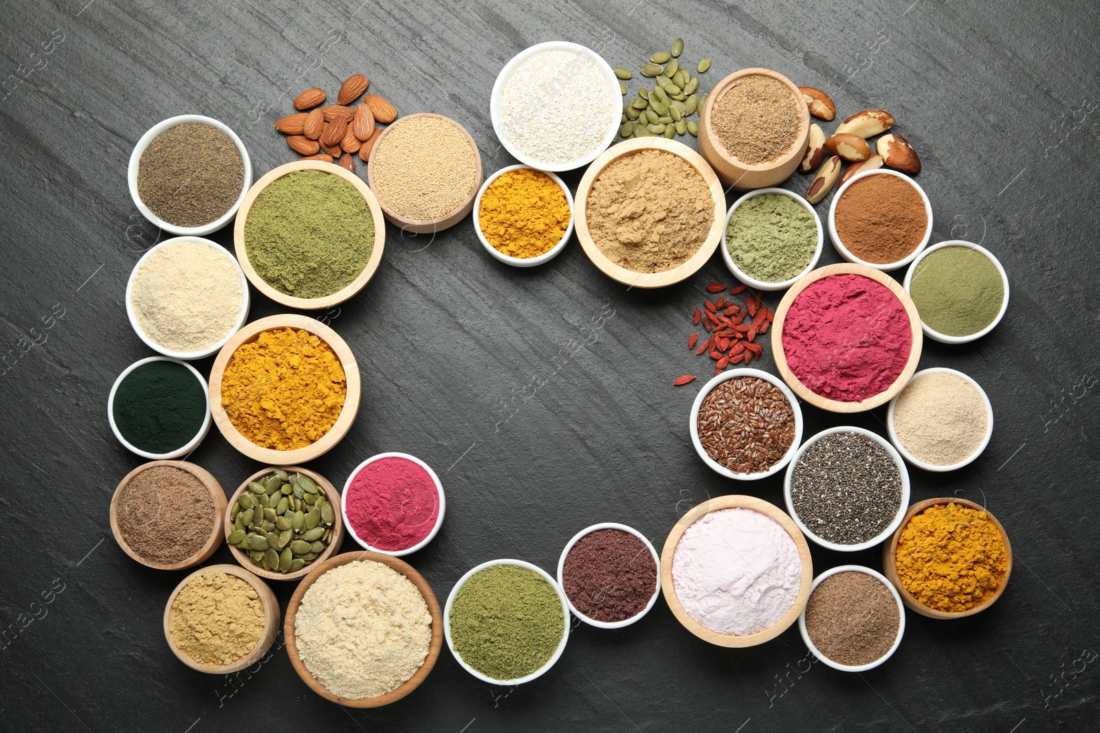 Frame of different superfood powders on black table, flat lay. Space for text Photo of Frame of different superfood powders on black table, flat lay. Space for text