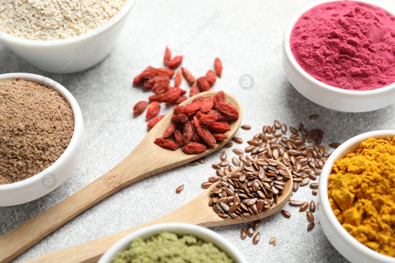 Different superfood powders on light grey table, closeup Photo of Different superfood powders on light grey table, closeup
