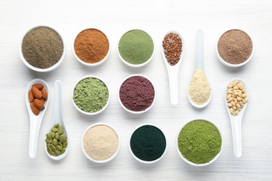 Photo of Different superfood powders on white wooden table, flat lay