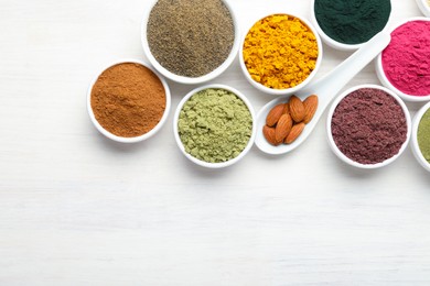 Photo of Different superfood powders on white wooden table, flat lay. Space for text