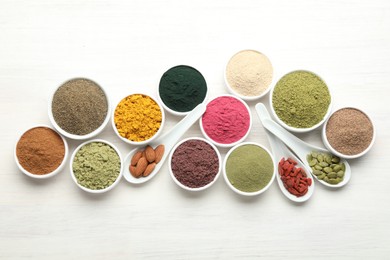Photo of Different superfood powders on white wooden table, flat lay