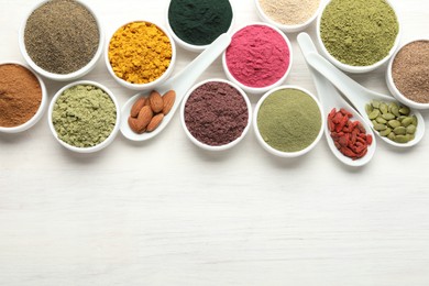 Photo of Different superfood powders on white wooden table, flat lay. Space for text