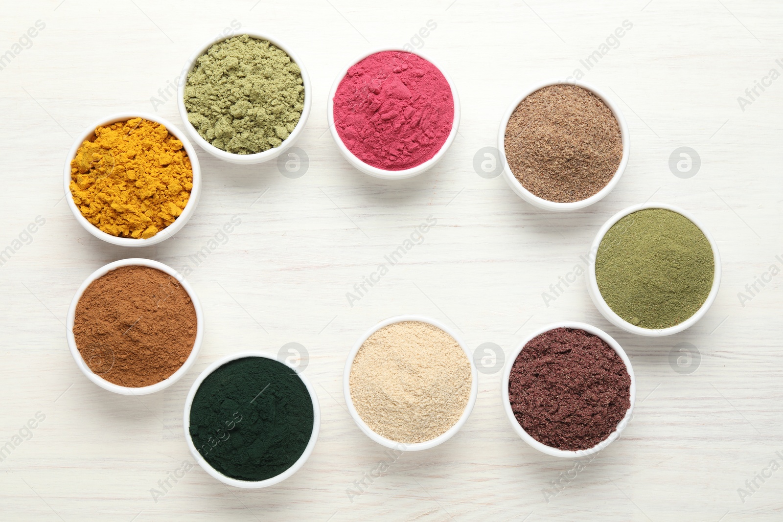 Frame of different superfood powders on white wooden table, flat lay. Space for text Photo of Frame of different superfood powders on white wooden table, flat lay. Space for text