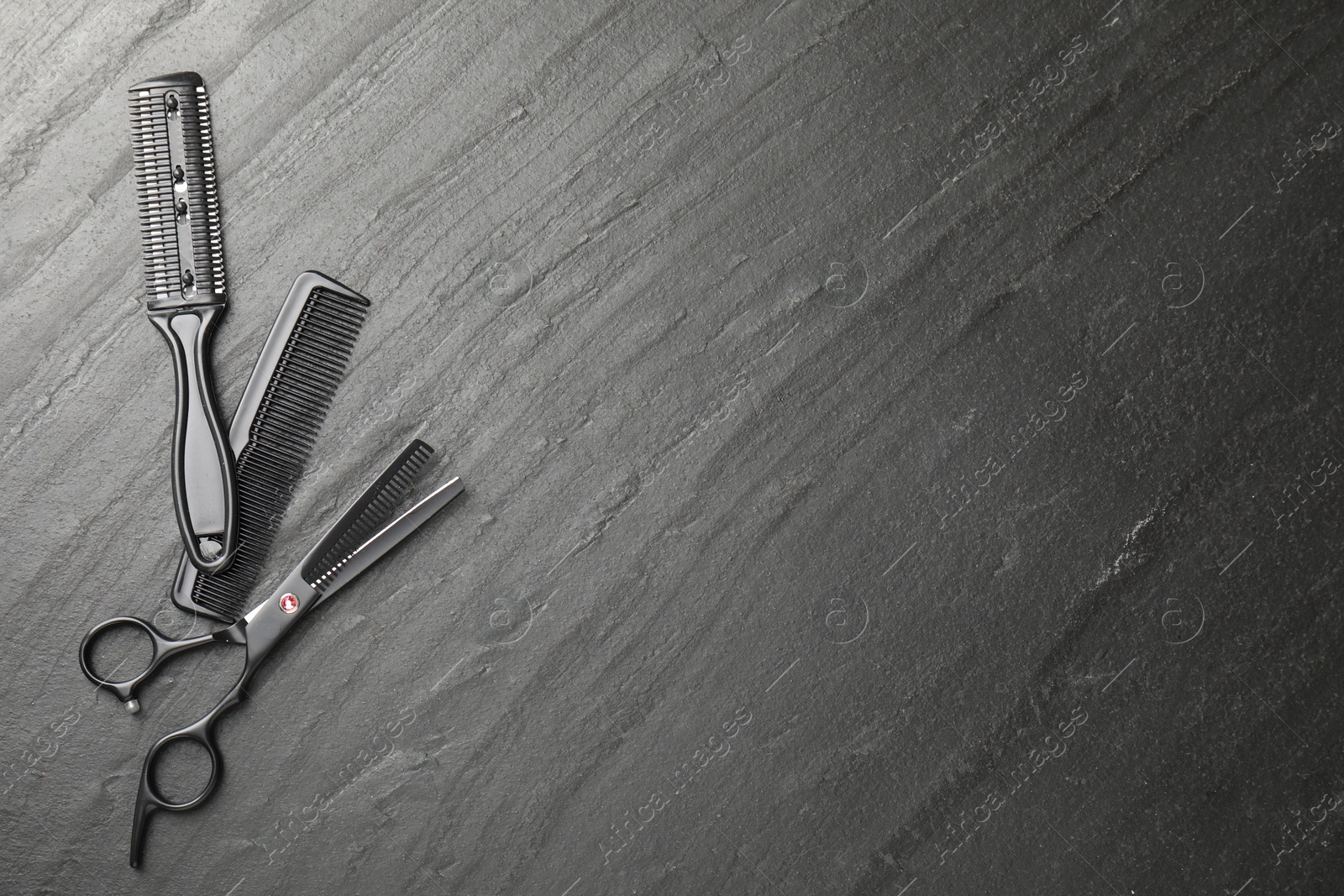 Different barber's tools on black table, flat lay. Space for text Photo of Different barber's tools on black table, flat lay. Space for text
