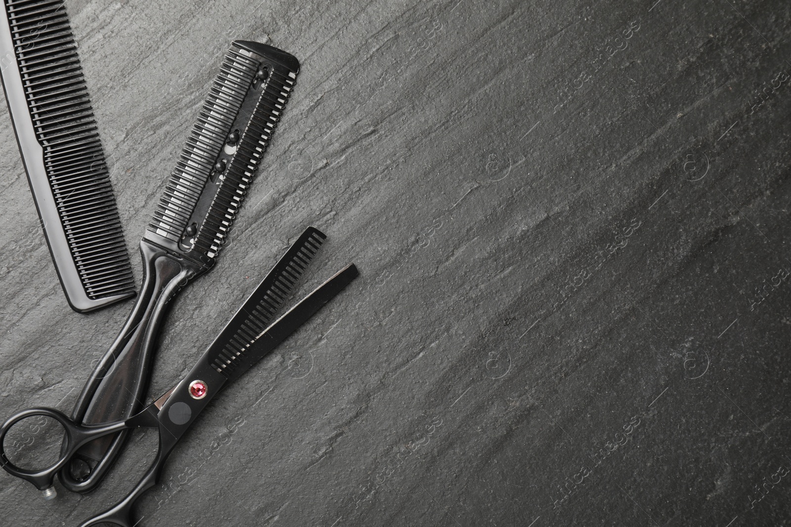 Different barber's tools on black table, flat lay. Space for text Photo of Different barber's tools on black table, flat lay. Space for text