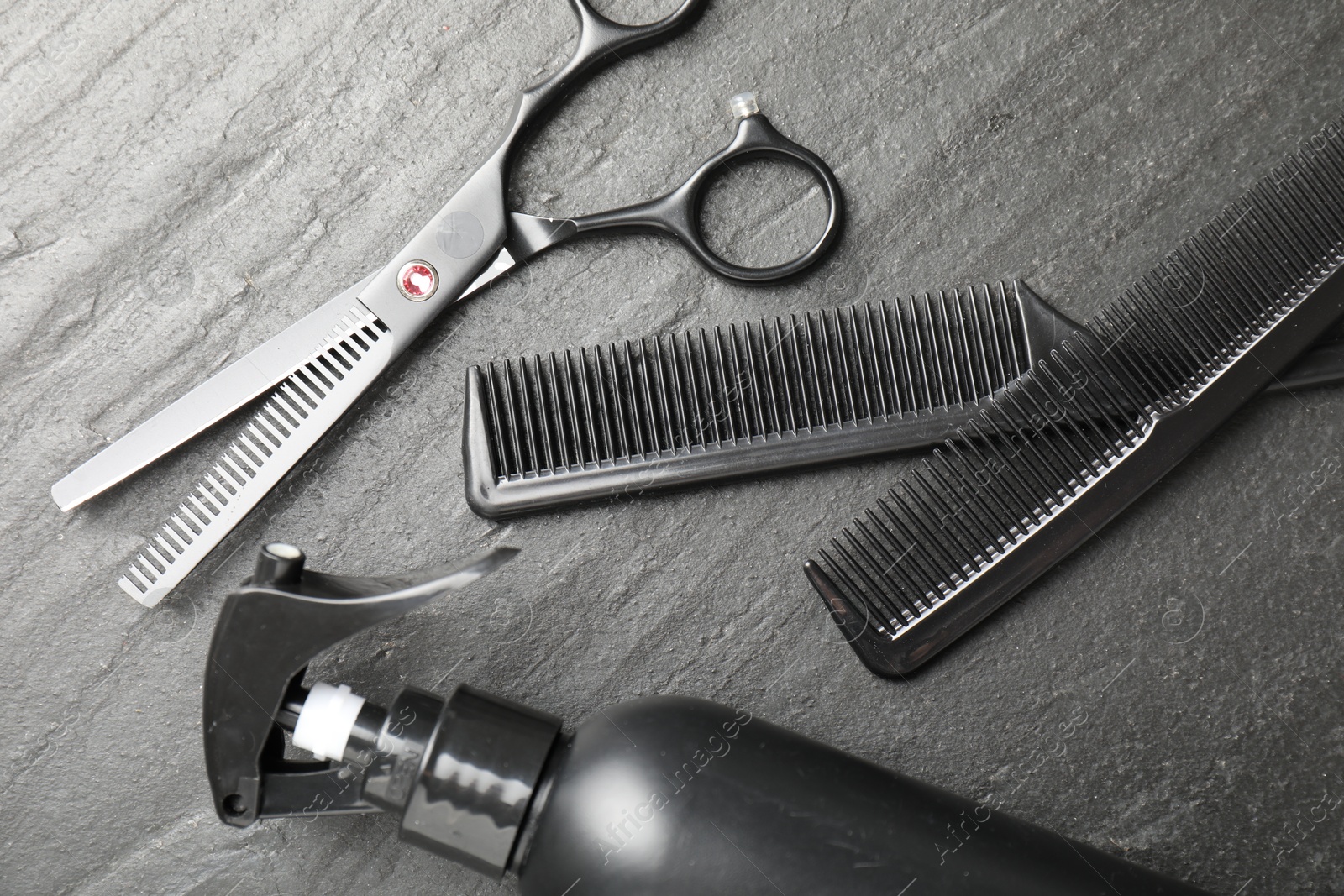 Different barber's tools on black table, flat lay Photo of Different barber's tools on black table, flat lay
