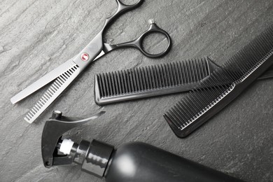 Photo of Different barber's tools on black table, flat lay