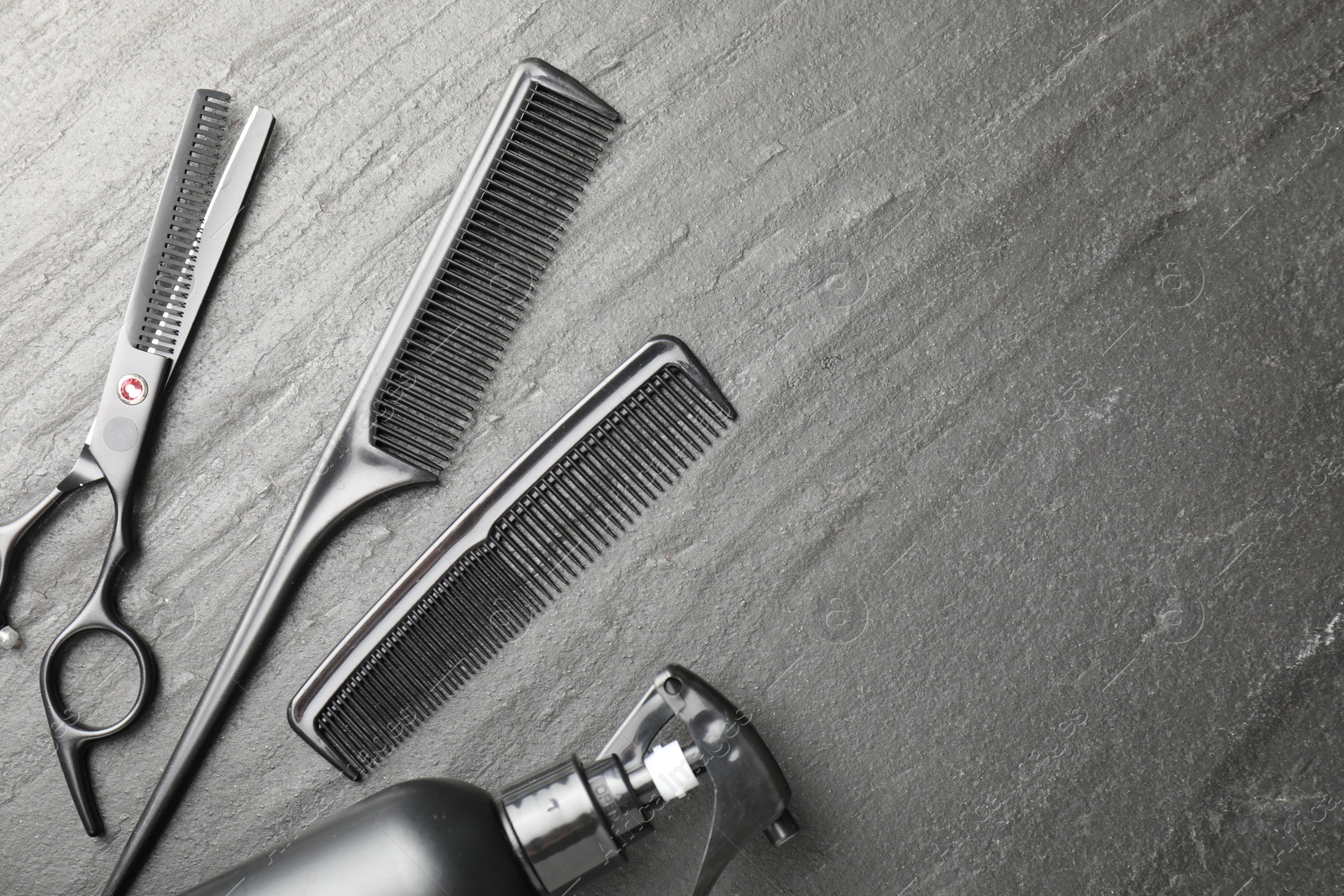 Different barber's tools on black table, flat lay. Space for text Photo of Different barber's tools on black table, flat lay. Space for text