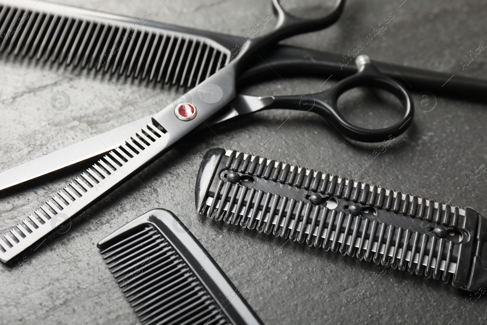 Different barber's tools on black table, closeup Photo of Different barber's tools on black table, closeup