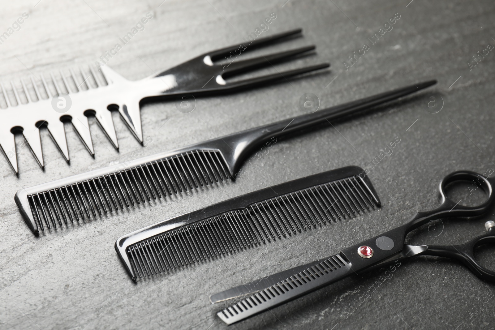 Different barber's tools on black table, closeup Photo of Different barber's tools on black table, closeup