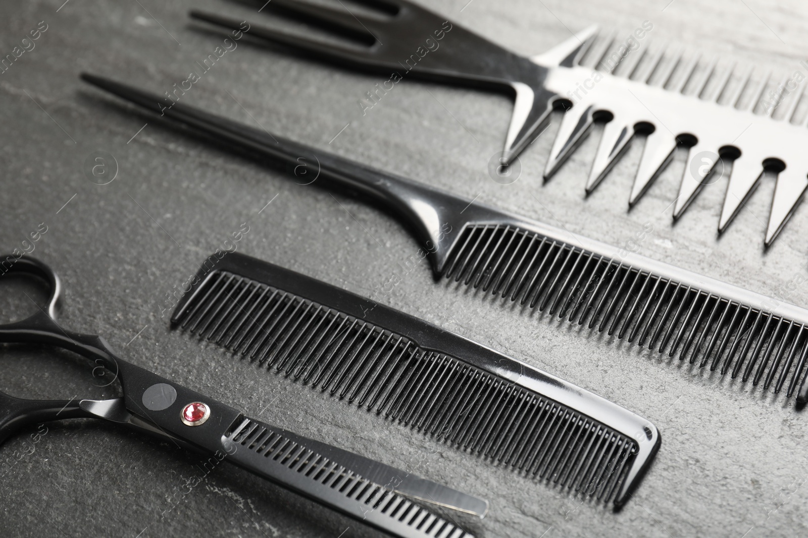 Different barber's tools on black table, closeup Photo of Different barber's tools on black table, closeup