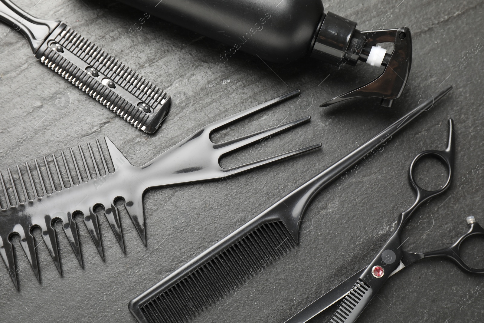 Different barber's tools on black table, flat lay Photo of Different barber's tools on black table, flat lay