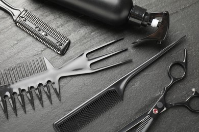 Photo of Different barber's tools on black table, flat lay