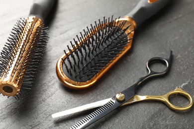 Photo of Different barber's tools on black table, closeup