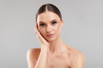 Photo of Portrait of beautiful young woman on gray background