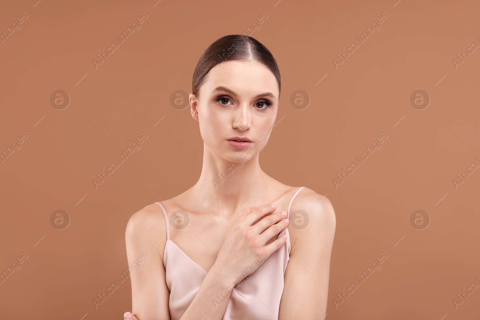 Portrait of beautiful young woman on beige background Photo of Portrait of beautiful young woman on beige background