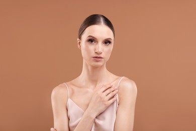 Photo of Portrait of beautiful young woman on beige background
