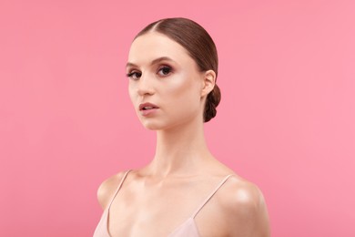 Photo of Portrait of beautiful young woman on pink background