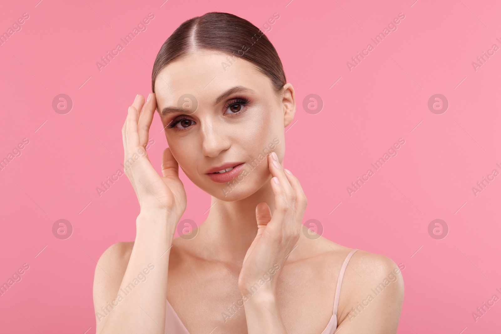 Portrait of beautiful young woman on pink background Photo of Portrait of beautiful young woman on pink background