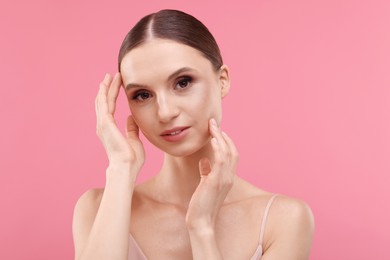 Photo of Portrait of beautiful young woman on pink background
