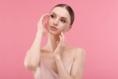 Photo of Portrait of beautiful young woman on pink background