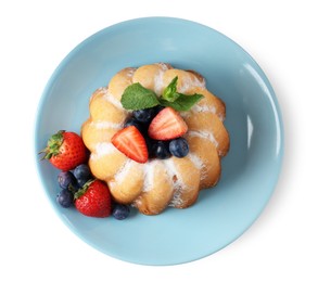 Photo of Tasty Bundt cake with powdered sugar and berries isolated on white, top view