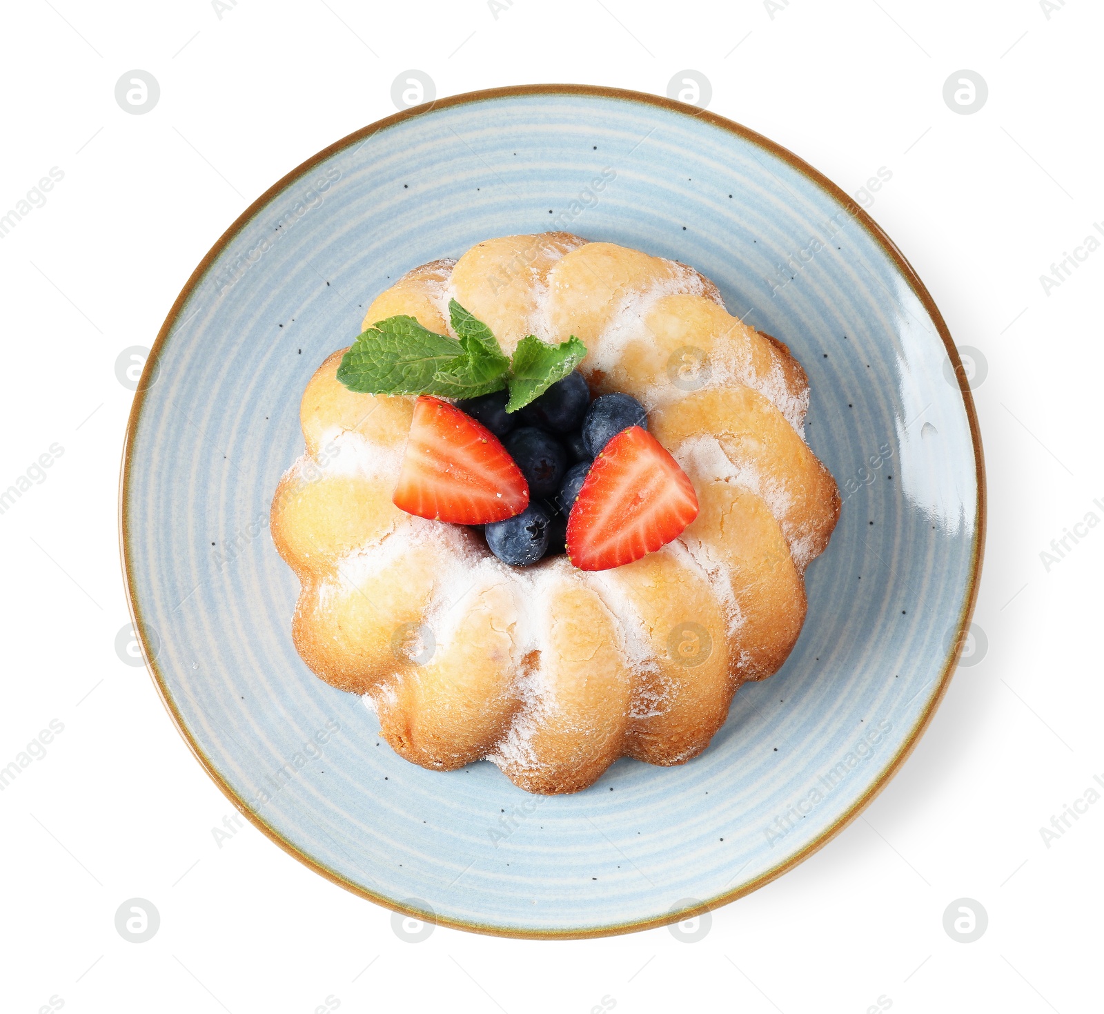 Tasty Bundt cake with powdered sugar and berries isolated on white, top view Photo of Tasty Bundt cake with powdered sugar and berries isolated on white, top view