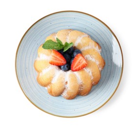 Photo of Tasty Bundt cake with powdered sugar and berries isolated on white, top view