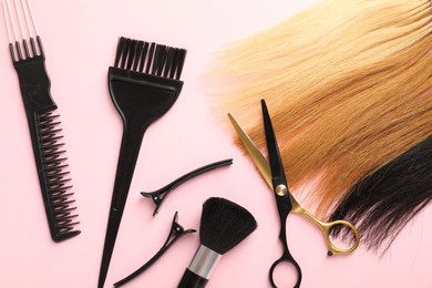 Photo of Hair strand and hairdresser's tools on light pink background, flat lay