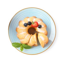 Photo of Tasty bundt cake with powdered sugar, berries and mint isolated on white, top view