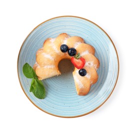 Photo of Tasty bundt cake with powdered sugar, berries and mint isolated on white, top view