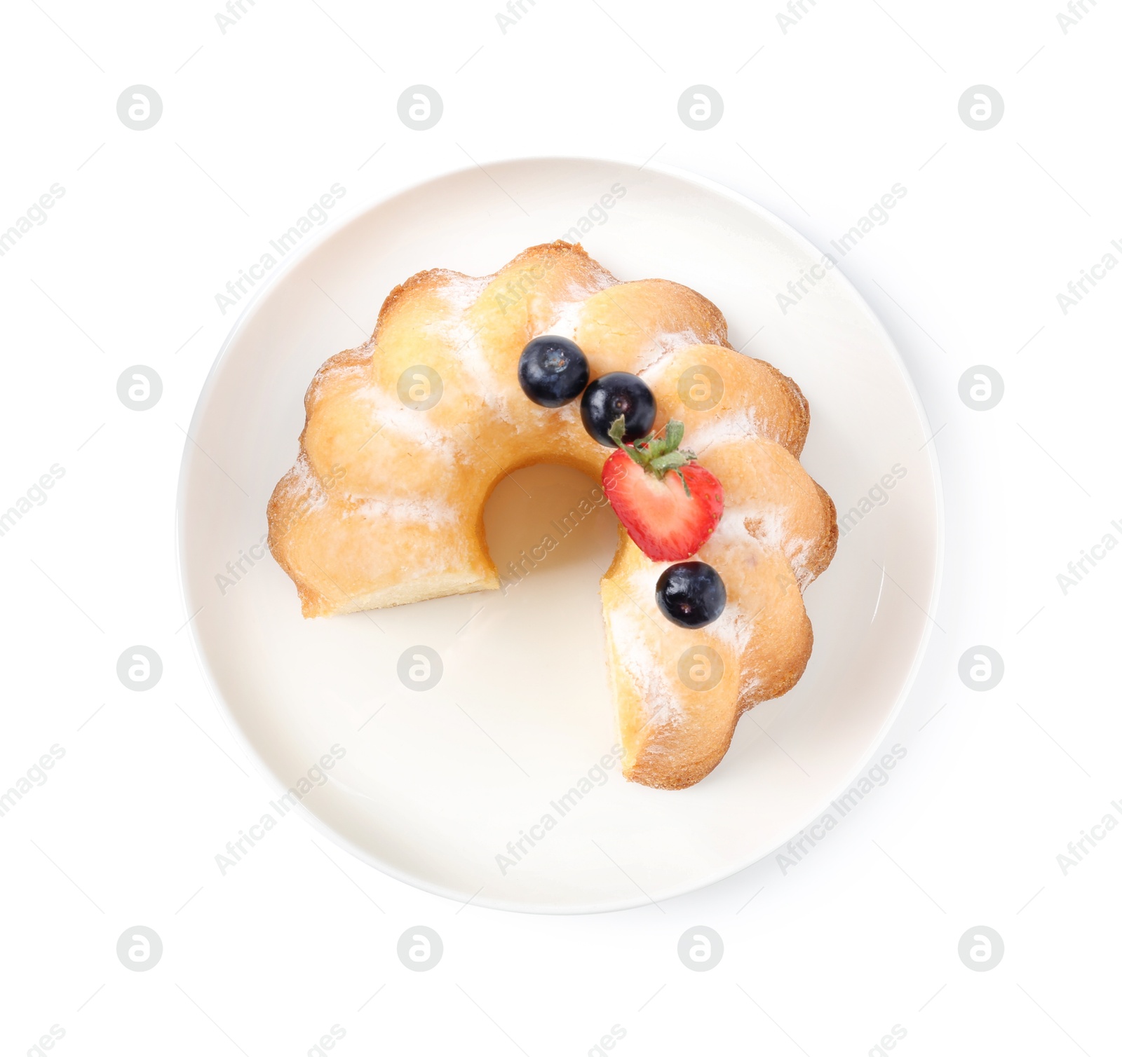 Tasty bundt cake with powdered sugar and berries isolated on white, top view Photo of Tasty bundt cake with powdered sugar and berries isolated on white, top view