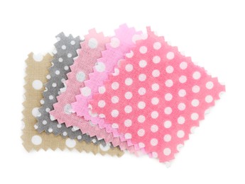 Photo of Samples of fabrics with polka dot pattern isolated on white, top view