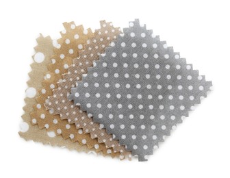Photo of Samples of fabrics with polka dot pattern isolated on white, top view