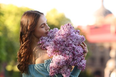 Photo of Beautiful woman with bouquet of lilac flowers outdoors in morning
