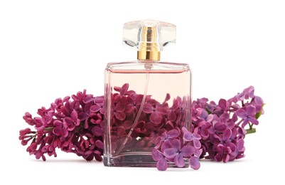 Photo of Bottle of luxury perfume and lilac flowers isolated on white