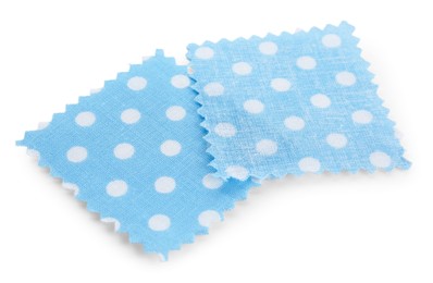 Photo of Samples of fabrics with polka dot pattern isolated on white