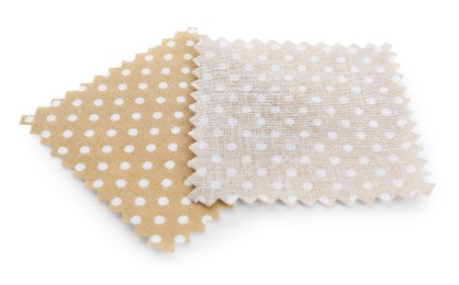 Photo of Samples of fabrics with polka dot pattern isolated on white