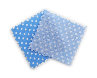 Photo of Samples of fabrics with polka dot pattern isolated on white, top view