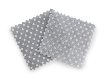 Photo of Samples of fabrics with polka dot pattern isolated on white, top view