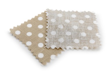 Photo of Samples of fabrics with polka dot pattern isolated on white