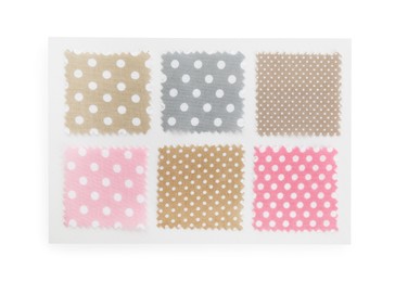 Photo of Samples of fabrics with polka dot pattern isolated on white, top view