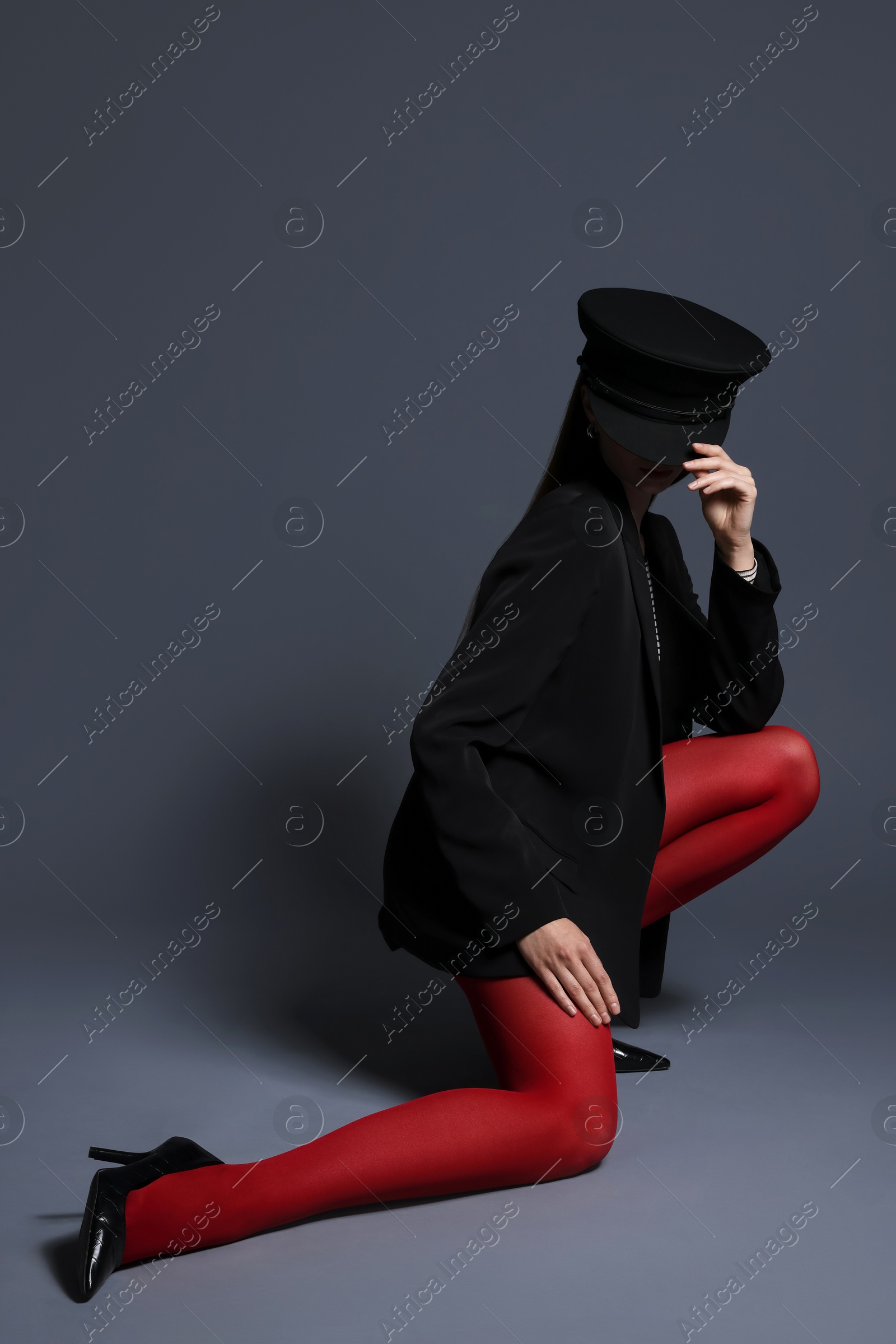 Fashionable portrait of beautiful woman in stylish outfit on grey background. Space for text Photo of Fashionable portrait of beautiful woman in stylish outfit on grey background. Space for text