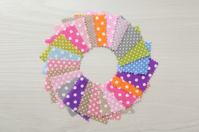 Photo of Samples of different fabrics on white wooden table, flat lay