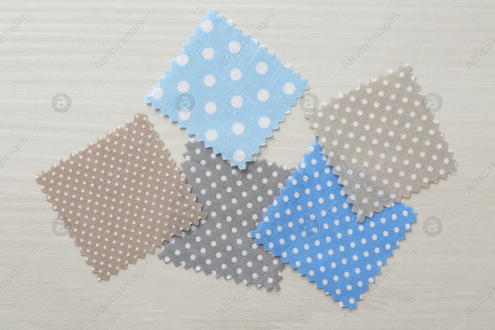 Samples of different fabrics on white wooden table, flat lay Photo of Samples of different fabrics on white wooden table, flat lay